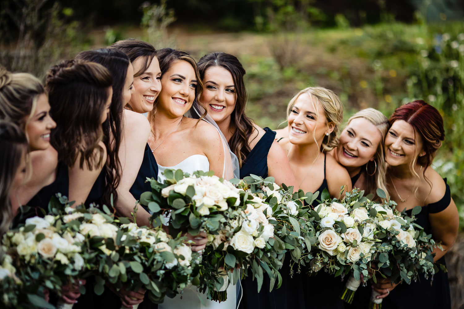 Bridesmaids smiling at the bride