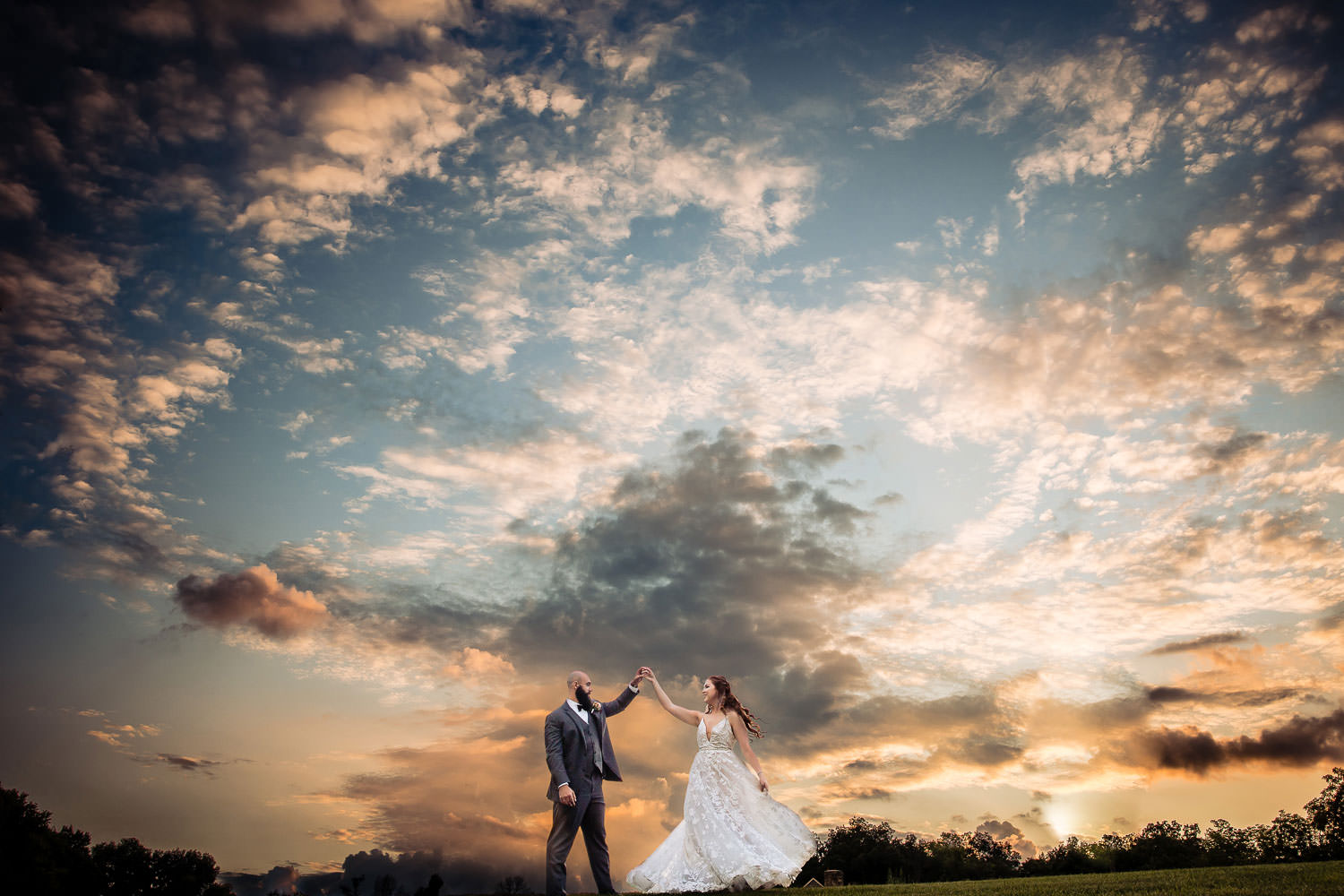 A married couple celebrating the wedding day under the sunset